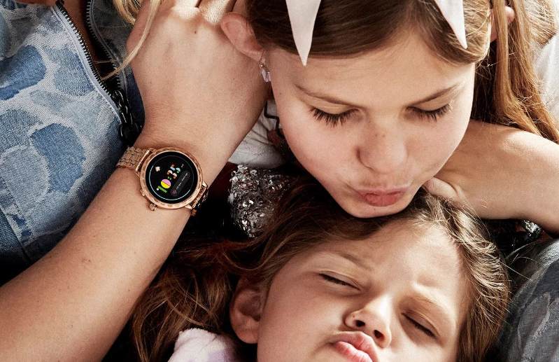 Mutter mit zwei Kindern trägt Kate Spade New York Scallop 2 Smartwatch am Handgelenk